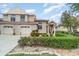 Charming two-story home with manicured landscaping and a white stucco facade at 814 Via Tripoli, Punta Gorda, FL 33950