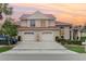 Charming two-story home with a rust colored roof, manicured landscaping, and a two-car garage at 814 Via Tripoli, Punta Gorda, FL 33950