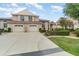 Charming two-story home with a rust colored roof, manicured landscaping, and a two-car garage at 814 Via Tripoli, Punta Gorda, FL 33950