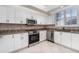 Charming kitchen with stainless appliances, light cabinets and granite countertops at 814 Via Tripoli, Punta Gorda, FL 33950