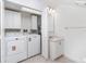 Functional laundry room with modern washer and dryer, storage cabinets at 814 Via Tripoli, Punta Gorda, FL 33950