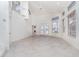 Bright and airy living room with tile floors, large windows, and French doors to the backyard at 814 Via Tripoli, Punta Gorda, FL 33950