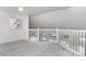 Carpeted upper loft with ceiling fan and white railing overlooking lower floor at 814 Via Tripoli, Punta Gorda, FL 33950