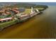 Aerial view of waterfront condos offering tranquil views, surrounded by water, a small lake and lush greenery at 95 N Marion Ct # 126, Punta Gorda, FL 33950