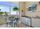 Inviting balcony features a table with chairs, a kitchenette, and a flat screen tv at 95 N Marion Ct # 126, Punta Gorda, FL 33950