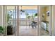 Enclosed balcony overlooking the water and featuring a ceiling fan, dining table, and convenient kitchenette at 95 N Marion Ct # 126, Punta Gorda, FL 33950