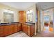 Nicely appointed bathroom with double sink, granite countertops, and honey-toned wood cabinetry at 95 N Marion Ct # 126, Punta Gorda, FL 33950