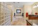 Bathroom with glass block shower and soaking tub at 95 N Marion Ct # 126, Punta Gorda, FL 33950