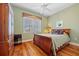 Cozy bedroom with hardwood floors, a ceiling fan, and a double hung window at 95 N Marion Ct # 126, Punta Gorda, FL 33950