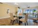 Dining room with glass-top table, stylish chandelier, and serene views from sliding glass doors at 95 N Marion Ct # 126, Punta Gorda, FL 33950