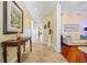 Inviting hallway with neutral tile, decorative art, and warm lighting creates an appealing entrance to the home at 95 N Marion Ct # 126, Punta Gorda, FL 33950