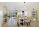 Bright living room featuring neutral walls, tile floors, a modern chandelier, and expansive views at 95 N Marion Ct # 126, Punta Gorda, FL 33950