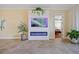 Stylish living room featuring a modern fireplace with an electric insert and views into the main bedroom at 95 N Marion Ct # 126, Punta Gorda, FL 33950