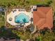 Aerial view of a community pool and spa, surrounded by lush greenery, providing a resort-like experience at 95 N Marion Ct # 126, Punta Gorda, FL 33950