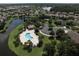Attractive aerial view of the community pool, parking area and surrounding homes nestled among mature trees and lush landscaping at 2836 Suncoast Lakes Blvd, Punta Gorda, FL 33980