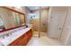 Beautiful bathroom with double sinks, walk-in shower, and tiled walls at 2836 Suncoast Lakes Blvd, Punta Gorda, FL 33980