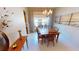 Elegant dining room with modern chandelier and beach-themed paintings at 2836 Suncoast Lakes Blvd, Punta Gorda, FL 33980