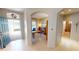 Bright and airy foyer featuring tile flooring, an open doorway, and a glimpse of the adjacent office space at 2836 Suncoast Lakes Blvd, Punta Gorda, FL 33980