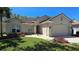 Charming home featuring a tile roof, two-car garage, inviting front yard, and meticulously landscaped flower beds at 2836 Suncoast Lakes Blvd, Punta Gorda, FL 33980