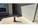 Close-up of the entryway with a decorative metal bird statue, brick pavers, and view of the front door at 2836 Suncoast Lakes Blvd, Punta Gorda, FL 33980