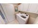 Bright laundry room featuring white cabinets, appliances, and a charming wall art at 2836 Suncoast Lakes Blvd, Punta Gorda, FL 33980