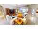 Beautiful living room with comfortable sofas, wooden cabinets, and a view to the screened-in patio at 2836 Suncoast Lakes Blvd, Punta Gorda, FL 33980