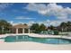Inviting community pool and cabana offers the perfect spot to relax and unwind with lounge chairs and lush landscaping at 2836 Suncoast Lakes Blvd, Punta Gorda, FL 33980