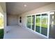 Spacious covered back porch with sliding glass doors, perfect for indoor-outdoor living at 10071 Sunday Dr, Port Charlotte, FL 33981