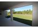 Covered patio overlooking a lush green backyard, ideal for outdoor relaxation at 10071 Sunday Dr, Port Charlotte, FL 33981