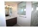 Modern bathroom featuring a glass-enclosed shower, double vanity, and decorative lighting at 10071 Sunday Dr, Port Charlotte, FL 33981