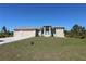 Charming single-story home featuring a three-car garage and well-manicured front lawn at 10071 Sunday Dr, Port Charlotte, FL 33981