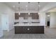 Bright kitchen featuring a large island with a sink and modern pendant lighting at 10071 Sunday Dr, Port Charlotte, FL 33981