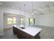 Open concept kitchen featuring quartz countertops and a seamless transition to the living area at 10071 Sunday Dr, Port Charlotte, FL 33981