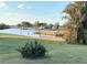 Picturesque waterfront property with lush greenery, offering serene views and potential for outdoor activities at 123 Poinsettia Ne Cir, Port Charlotte, FL 33952