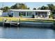 Backyard with waterfront access featuring a private dock, ideal for boating and enjoying waterfront living at 123 Poinsettia Ne Cir, Port Charlotte, FL 33952