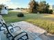 View of the lush backyard that leads to the canal with space to enjoy water activities at 123 Poinsettia Ne Cir, Port Charlotte, FL 33952