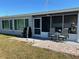Back patio offering a relaxing spot with outdoor seating and views of the backyard at 123 Poinsettia Ne Cir, Port Charlotte, FL 33952