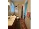 Quaint bathroom showcasing mosaic tile flooring, vanity, toilet and framed mirror at 123 Poinsettia Ne Cir, Port Charlotte, FL 33952