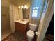 Compact bathroom featuring a vanity, toilet, and shower with tiled walls for easy maintenance and cleanliness at 123 Poinsettia Ne Cir, Port Charlotte, FL 33952