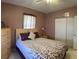 Bedroom features comfortable bedding, closet space, and natural light at 123 Poinsettia Ne Cir, Port Charlotte, FL 33952