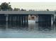 Concrete bridge supports over calm water create a scenic waterfront view at 123 Poinsettia Ne Cir, Port Charlotte, FL 33952