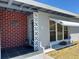 Close-up of home entrance with tiled porch and decorative brickwork at 123 Poinsettia Ne Cir, Port Charlotte, FL 33952