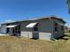Well-maintained single-story home with awnings and a tidy lawn at 123 Poinsettia Ne Cir, Port Charlotte, FL 33952