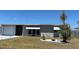 Charming single-story home with well-maintained lawn and inviting curb appeal under a clear blue sky at 123 Poinsettia Ne Cir, Port Charlotte, FL 33952