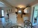 Bright eat-in kitchen featuring tile floors, white cabinets, and modern appliances at 123 Poinsettia Ne Cir, Port Charlotte, FL 33952
