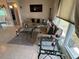 Bright living room with large windows, neutral decor, glass tables and tile floors at 123 Poinsettia Ne Cir, Port Charlotte, FL 33952