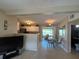 Open floor plan with living, dining, and kitchen areas featuring tiled floors at 123 Poinsettia Ne Cir, Port Charlotte, FL 33952
