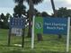 Port Charlotte Beach Park sign with park rules posted, indicating a Gathering-friendly environment at 123 Poinsettia Ne Cir, Port Charlotte, FL 33952