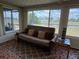 Cozy sunroom featuring comfortable seating, ample natural light, and scenic water views for relaxation at 123 Poinsettia Ne Cir, Port Charlotte, FL 33952