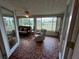 Inviting sun room with tiled floor, and canal view at 123 Poinsettia Ne Cir, Port Charlotte, FL 33952